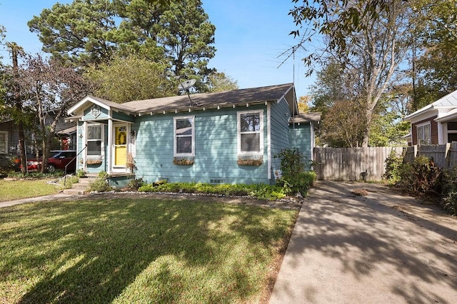 bungalow-style house featuring crawl space, fence, and a front yard