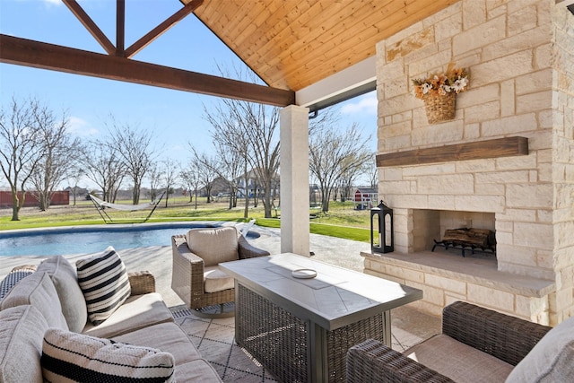 view of patio / terrace with an outdoor stone fireplace and an outdoor pool