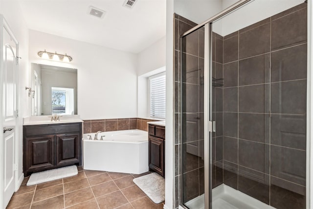 full bath featuring a garden tub, vanity, visible vents, a shower stall, and tile patterned floors