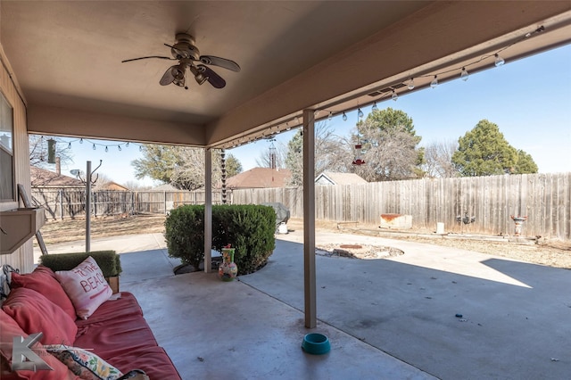 view of patio with a fenced backyard and a ceiling fan