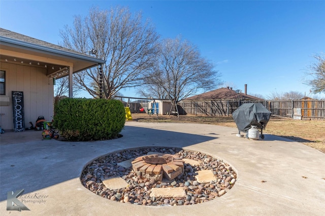 view of patio / terrace featuring a fire pit, area for grilling, and a fenced backyard