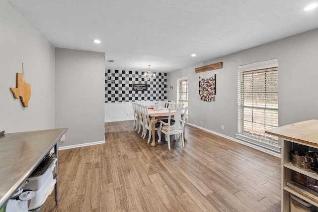 dining area featuring light wood finished floors, baseboards, a chandelier, and recessed lighting