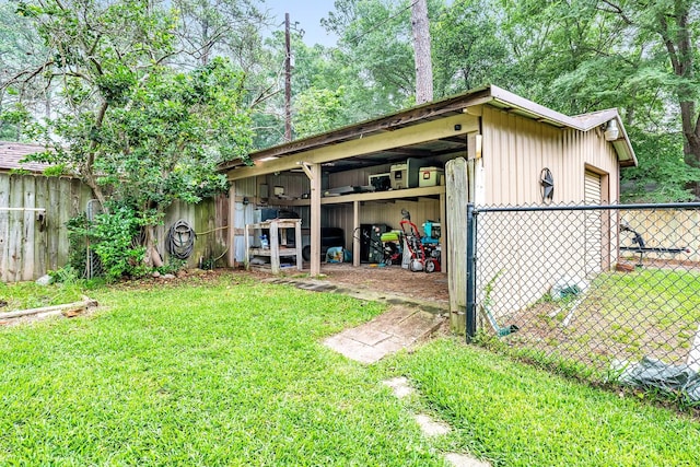 view of pole building featuring a garage, fence, and a yard