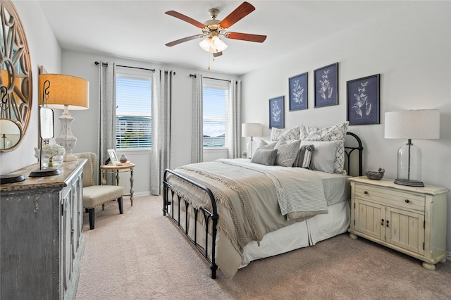 bedroom with ceiling fan and light colored carpet