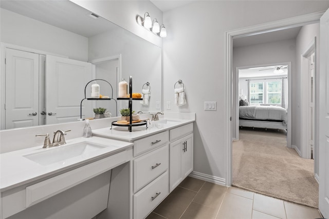 full bathroom featuring tile patterned floors, a sink, ensuite bath, and double vanity