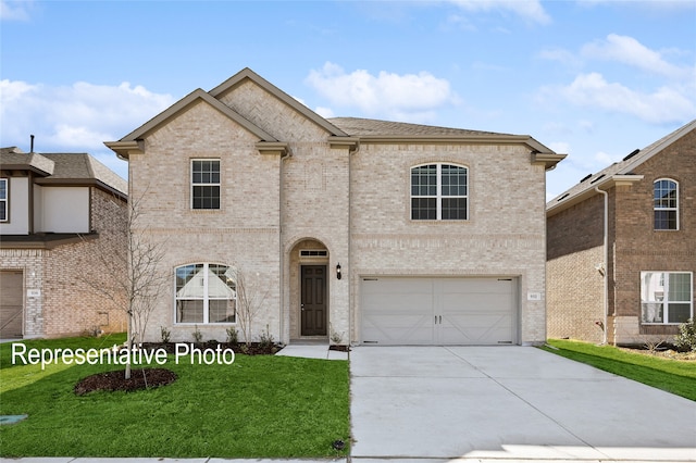 view of front of house with an attached garage, driveway, brick siding, and a front yard