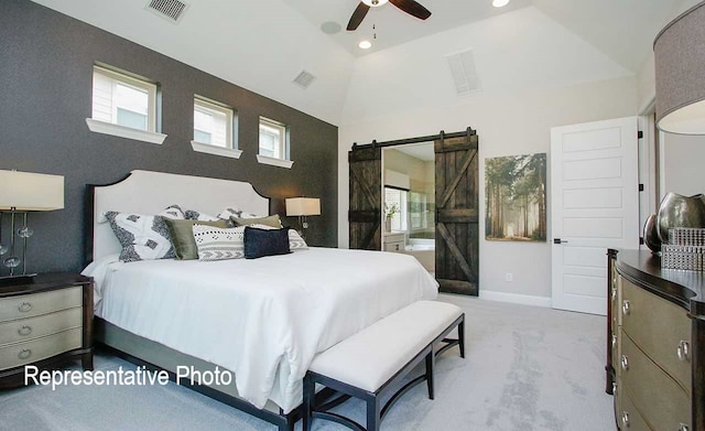 bedroom featuring a barn door, multiple windows, vaulted ceiling, and carpet flooring