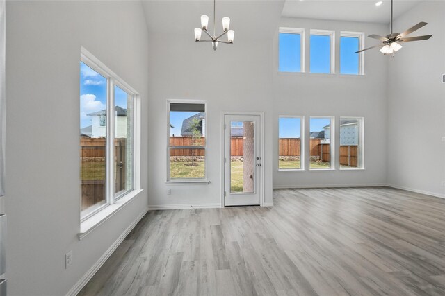 bedroom with baseboards, vaulted ceiling, and light colored carpet