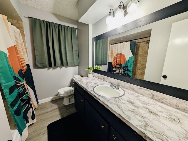 873 Beverly Dr, Terrell, TX 75160 - bathroom featuring wood finished floors, vanity, toilet, baseboards, and a shower with shower curtain