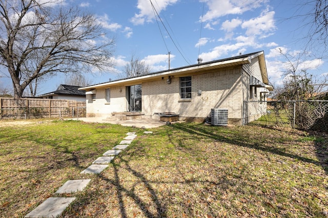 873 Beverly Dr, Terrell, TX 75160 - rear view of property with brick siding and central AC