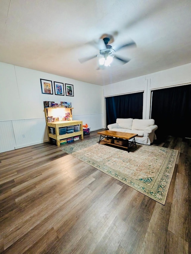 873 Beverly Dr, Terrell, TX 75160 - living area featuring ceiling fan, a wainscoted wall, and wood finished floors