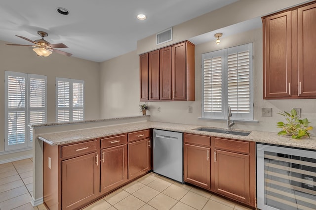 kitchen with beverage cooler, a peninsula, a sink, visible vents, and dishwasher