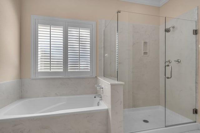 full bath featuring a garden tub and a marble finish shower