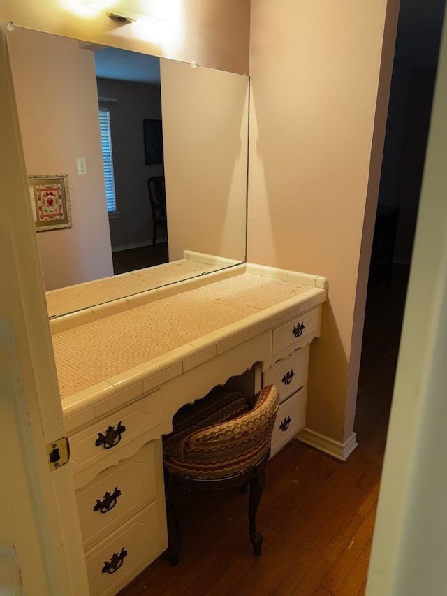 bathroom with wood finished floors, vanity, and baseboards