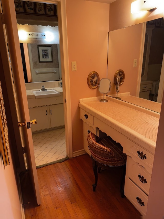 bathroom with a sink and wood finished floors