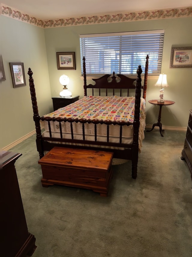 bedroom with dark carpet and baseboards