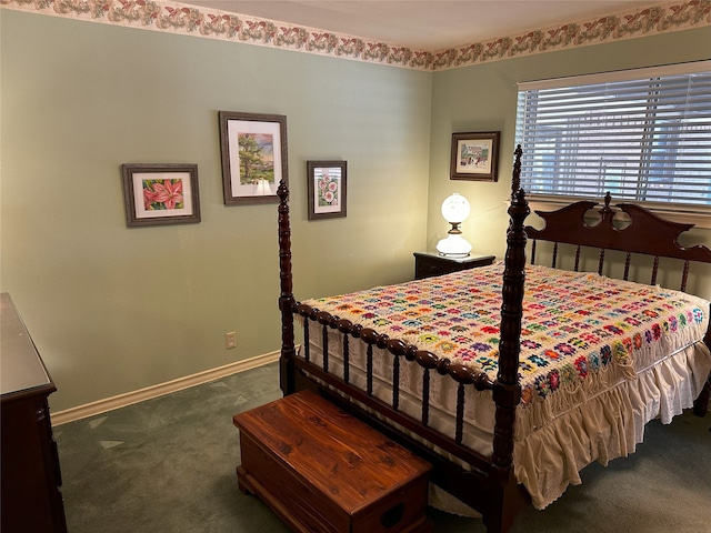 bedroom featuring dark carpet and baseboards