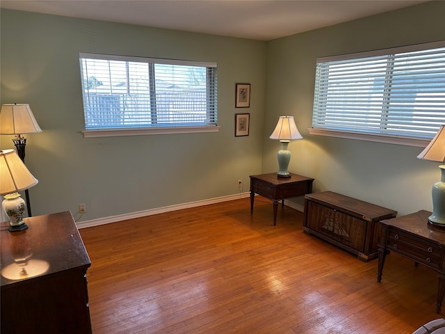 sitting room with wood finished floors and baseboards