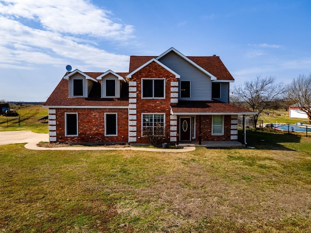 view of front of house featuring covered porch, a shingled roof, a front lawn, and brick siding