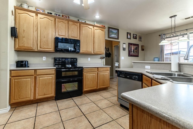 kitchen featuring decorative light fixtures, light countertops, visible vents, a sink, and black appliances