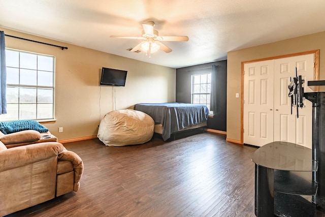 bedroom with a ceiling fan, baseboards, and dark wood-style flooring