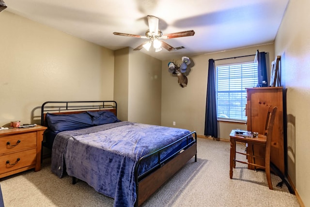 bedroom with baseboards, ceiling fan, visible vents, and light colored carpet