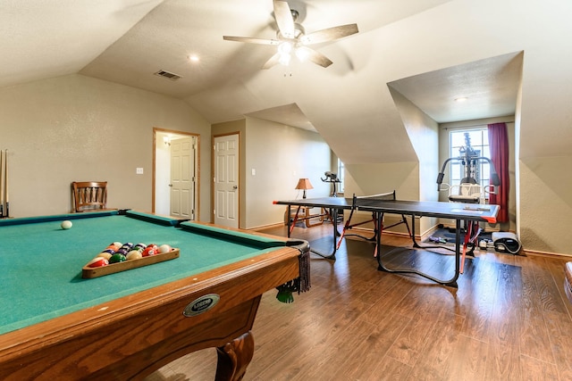 recreation room featuring lofted ceiling, wood finished floors, visible vents, baseboards, and a ceiling fan