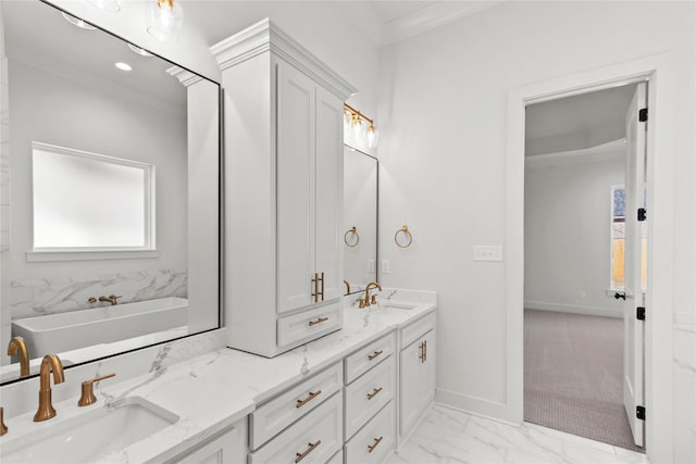 full bathroom with marble finish floor, a sink, baseboards, and double vanity