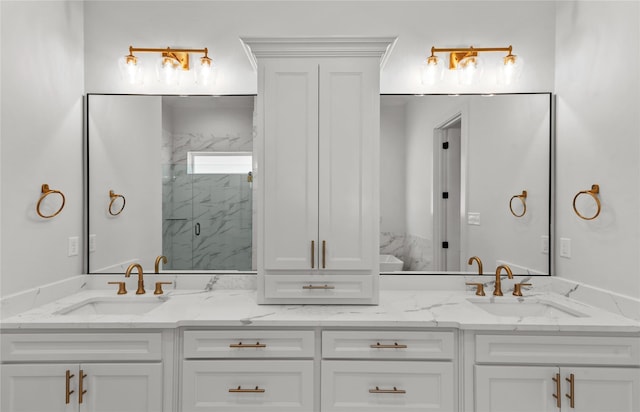 bathroom featuring double vanity, a marble finish shower, and a sink