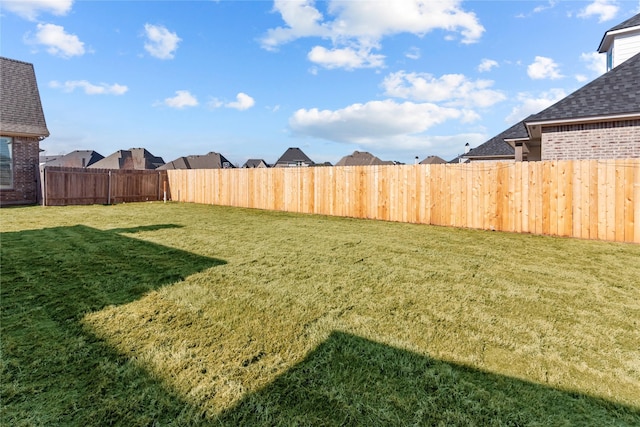 view of yard with a fenced backyard