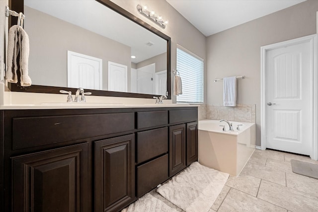 full bathroom featuring a bath, double vanity, and a sink