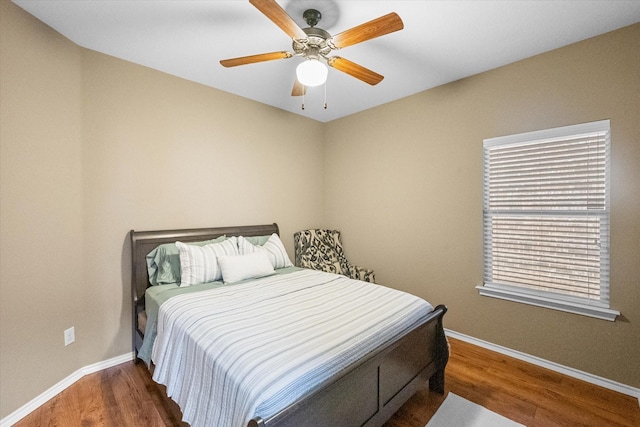 bedroom featuring ceiling fan, baseboards, and dark wood-style flooring