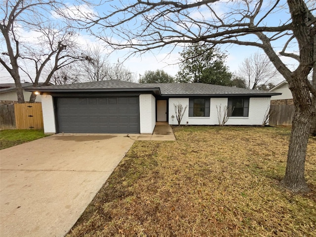 view of front of house featuring a garage, concrete driveway, brick siding, and a front lawn