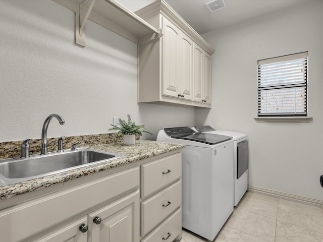 1300 Ruby Lea Ln, Fort Worth, TX 76179 - laundry area with washer and dryer, cabinet space, and light tile patterned floors
