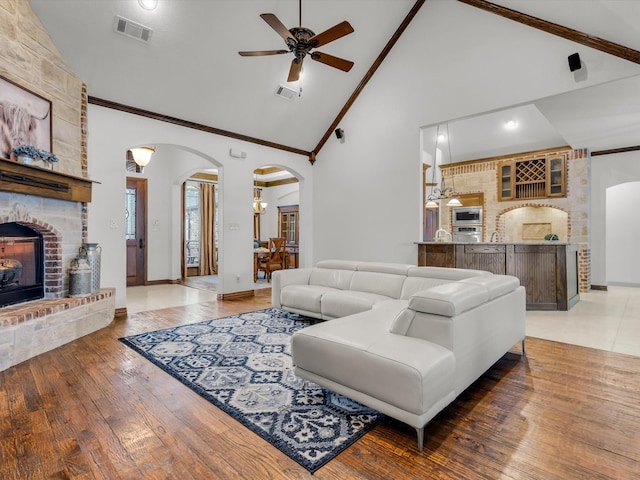 1300 Ruby Lea Ln, Fort Worth, TX 76179 - living area featuring arched walkways, crown molding, ceiling fan, a brick fireplace, and high vaulted ceiling