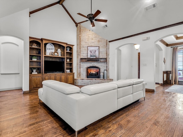 1300 Ruby Lea Ln, Fort Worth, TX 76179 - living area featuring a ceiling fan, arched walkways, wood finished floors, a fireplace, and high vaulted ceiling