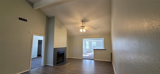 unfurnished living room featuring a fireplace, visible vents, baseboards, a ceiling fan, and dark wood-style floors