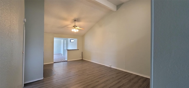 spare room with dark wood-type flooring, lofted ceiling with beams, baseboards, and a ceiling fan