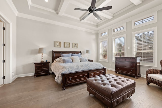 bedroom with beamed ceiling, coffered ceiling, light wood-style flooring, and baseboards