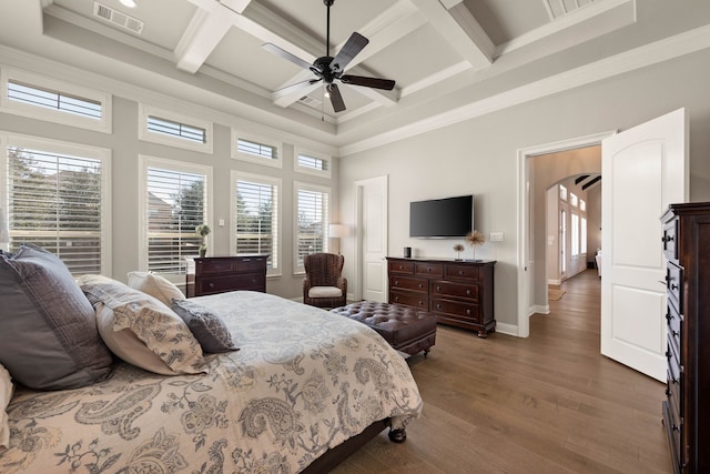 bedroom featuring multiple windows, visible vents, arched walkways, and dark wood-type flooring