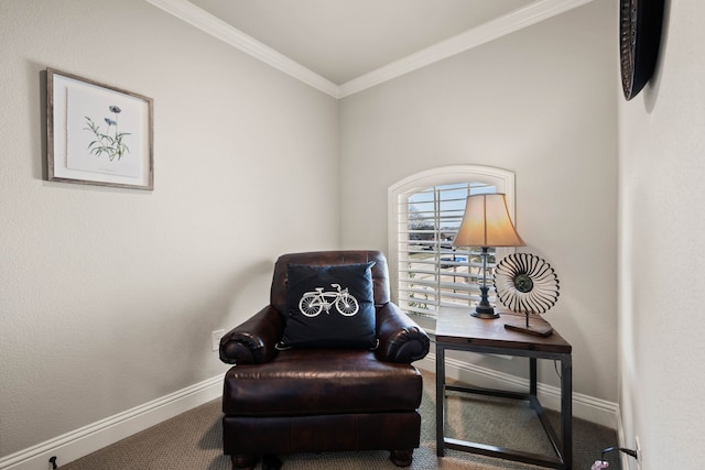 sitting room with carpet floors, ornamental molding, and baseboards