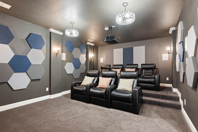 carpeted cinema room with baseboards, visible vents, and a textured ceiling