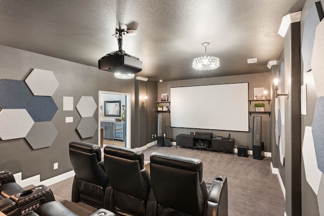 carpeted home theater room featuring a textured ceiling, a notable chandelier, and baseboards