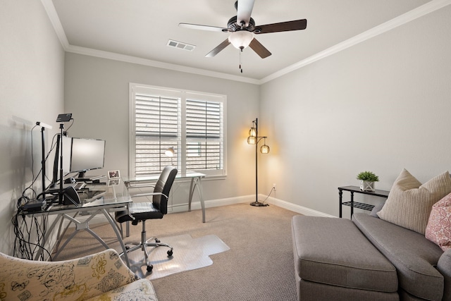 office featuring baseboards, visible vents, a ceiling fan, ornamental molding, and carpet flooring