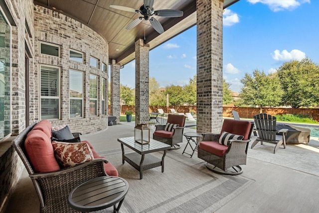 view of patio featuring a ceiling fan, outdoor lounge area, and a fenced backyard