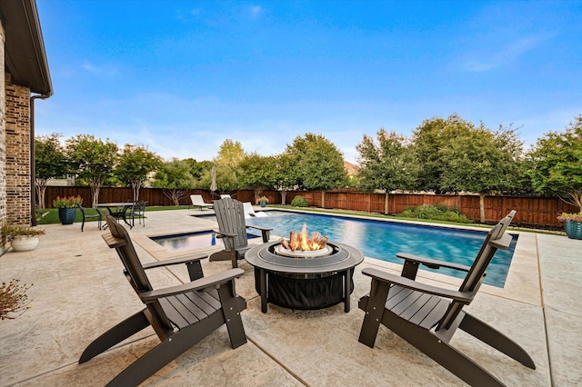 view of pool featuring a fire pit, a patio, and a fenced backyard