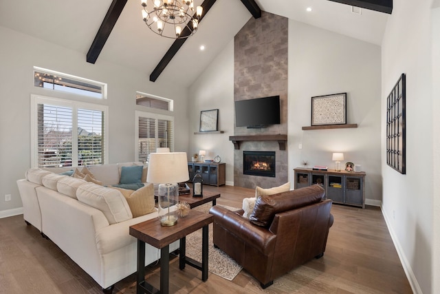 living area with wood finished floors, high vaulted ceiling, a tile fireplace, beamed ceiling, and baseboards