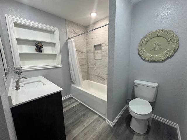 full bathroom featuring toilet, wood finished floors, vanity, baseboards, and shower / bath combination with curtain