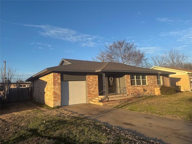 ranch-style home featuring brick siding, an attached garage, a front yard, fence, and driveway