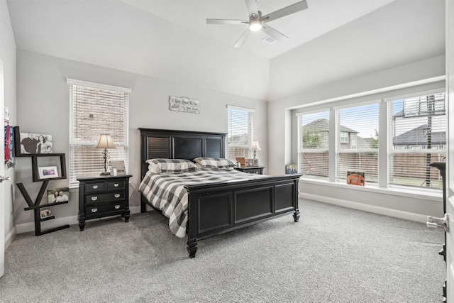 carpeted bedroom with vaulted ceiling, baseboards, and ceiling fan